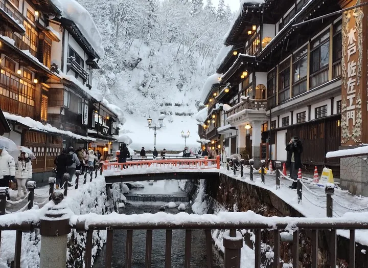 Ginzan Onsen inns and bridges covered in snow along the river