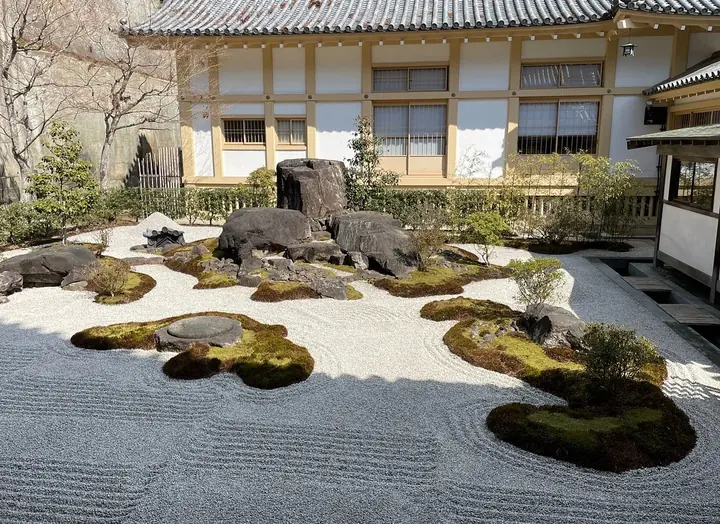 A raked gravel Zen garden with moss and rocks